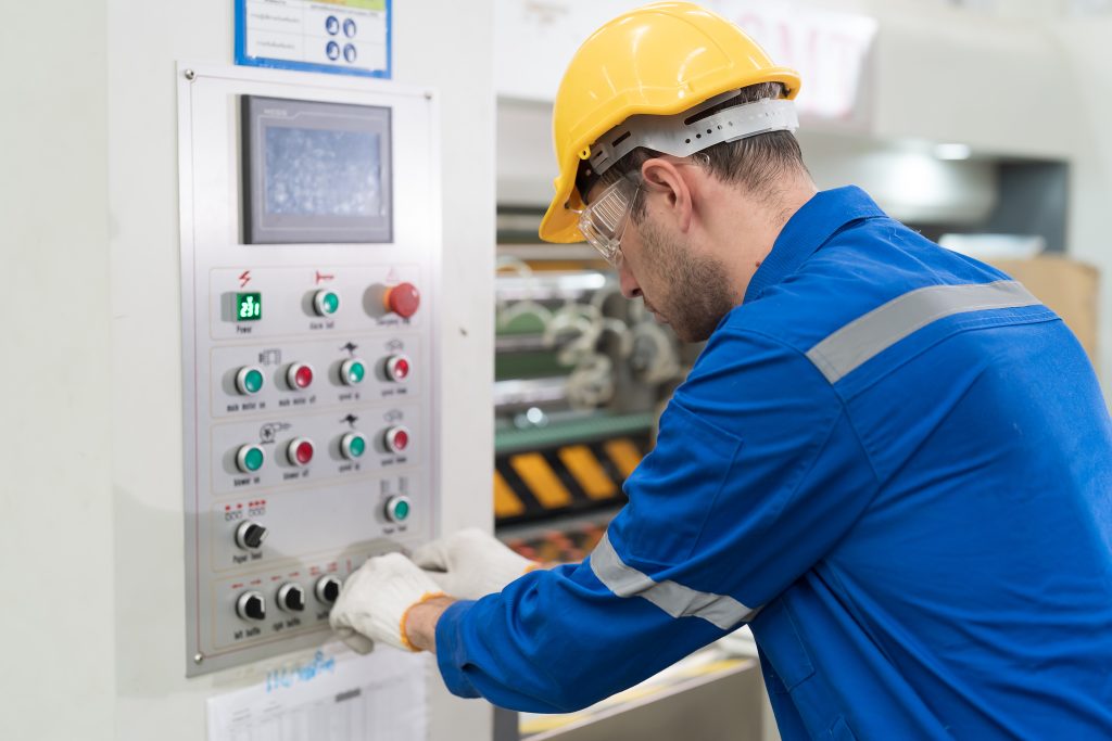 Electrician controlling electric system in industry factory